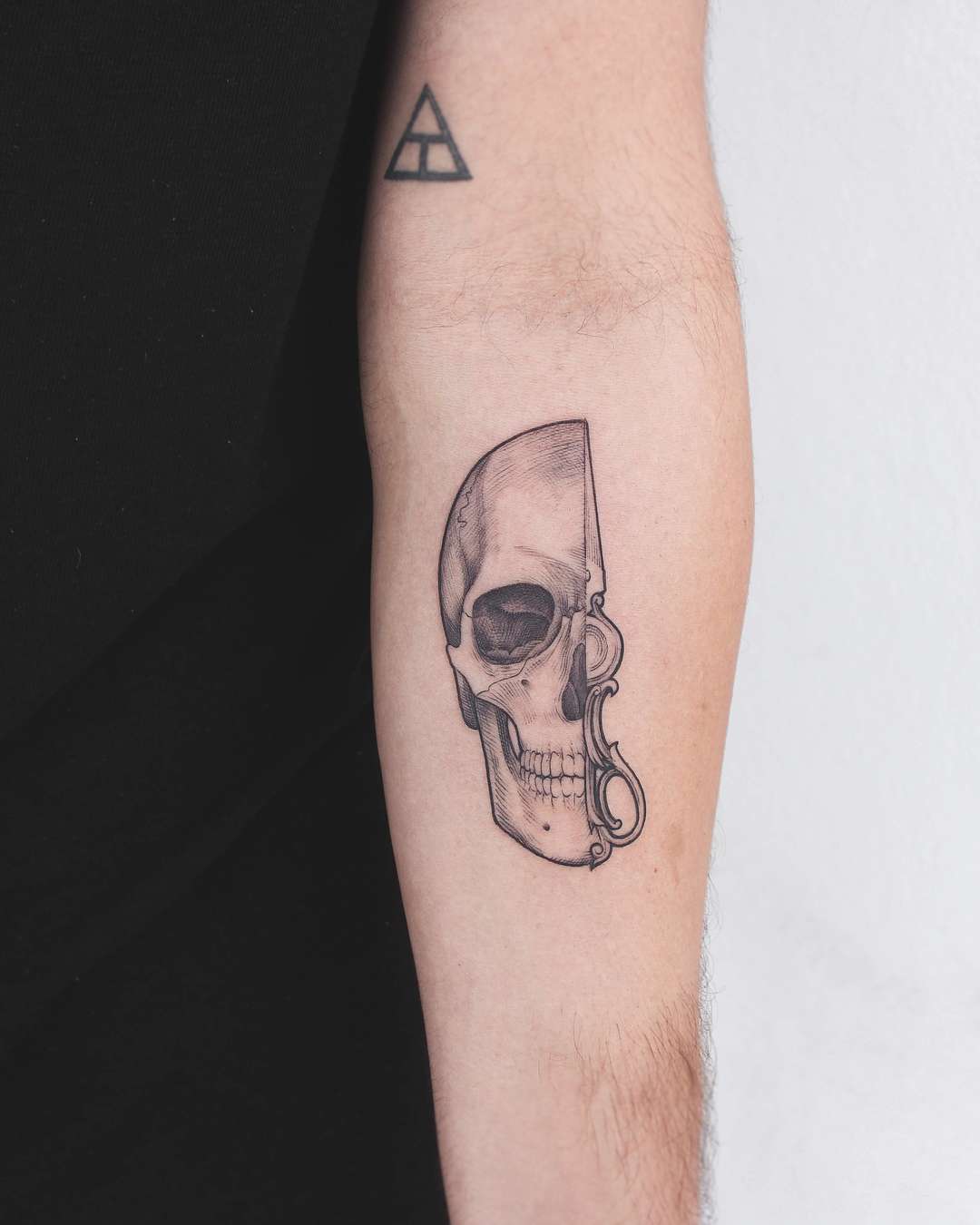 Minimal skull finger tattoo