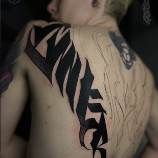 Female Black Lettering tattoo on Back #100684 | Tattoo Artist Perforator Tattoo Studio