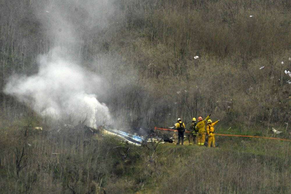 Firefighters work the scene of a helicopter crash where former NBA star Kobe Bryant died, Sunday, Jan. 26, 2020, in Calabasas, Calif.