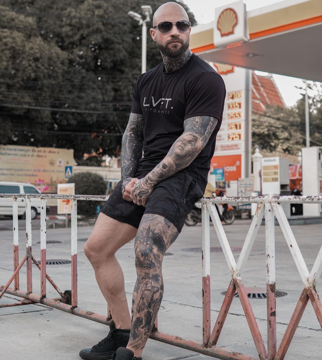 Free Photo  Powerful stylish bodybuilder with tattoo on his arm doing the  exercises on a biceps with dumbbells looking at a camera isolated on a  dark background