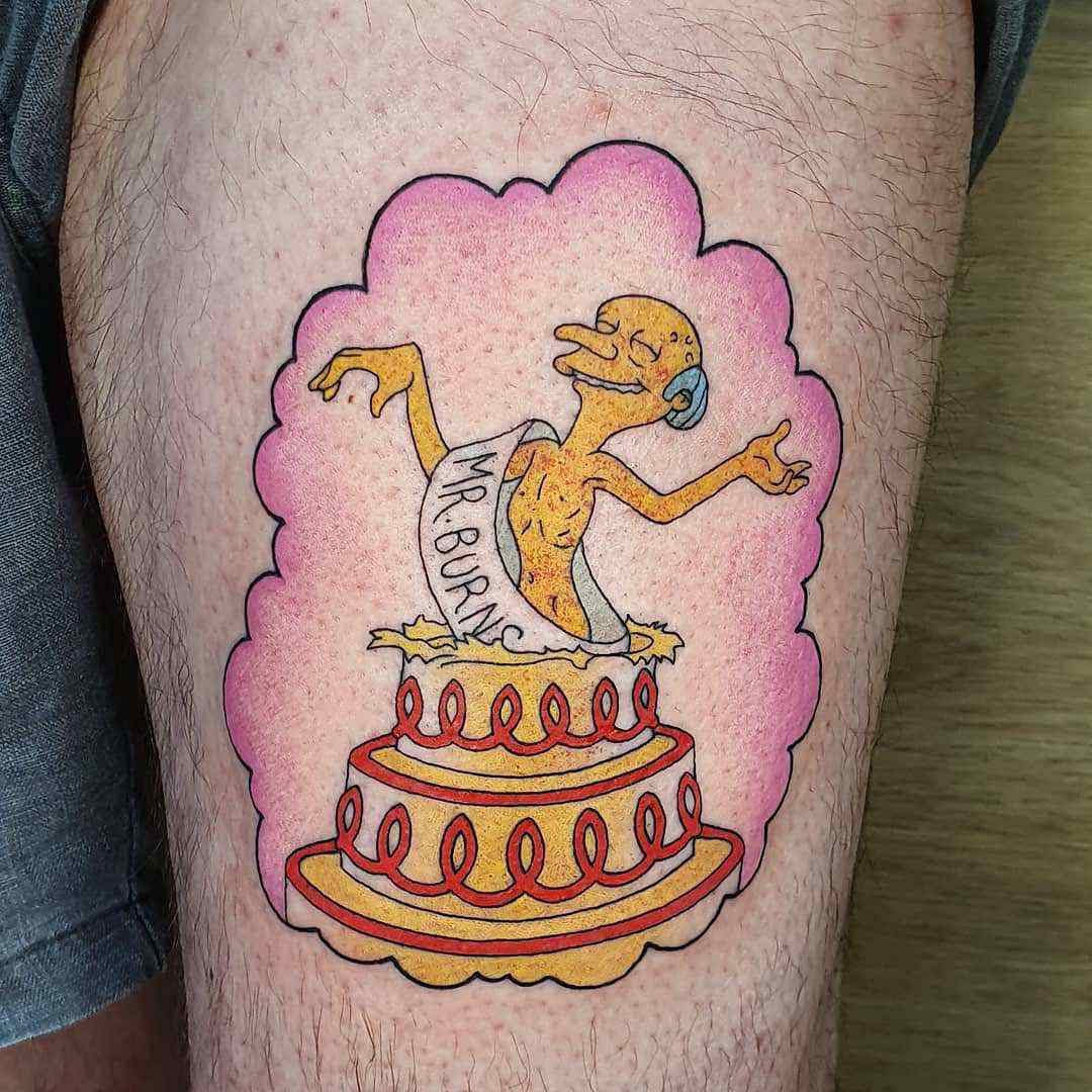 Mr. Burns pops out of the cake tattoo