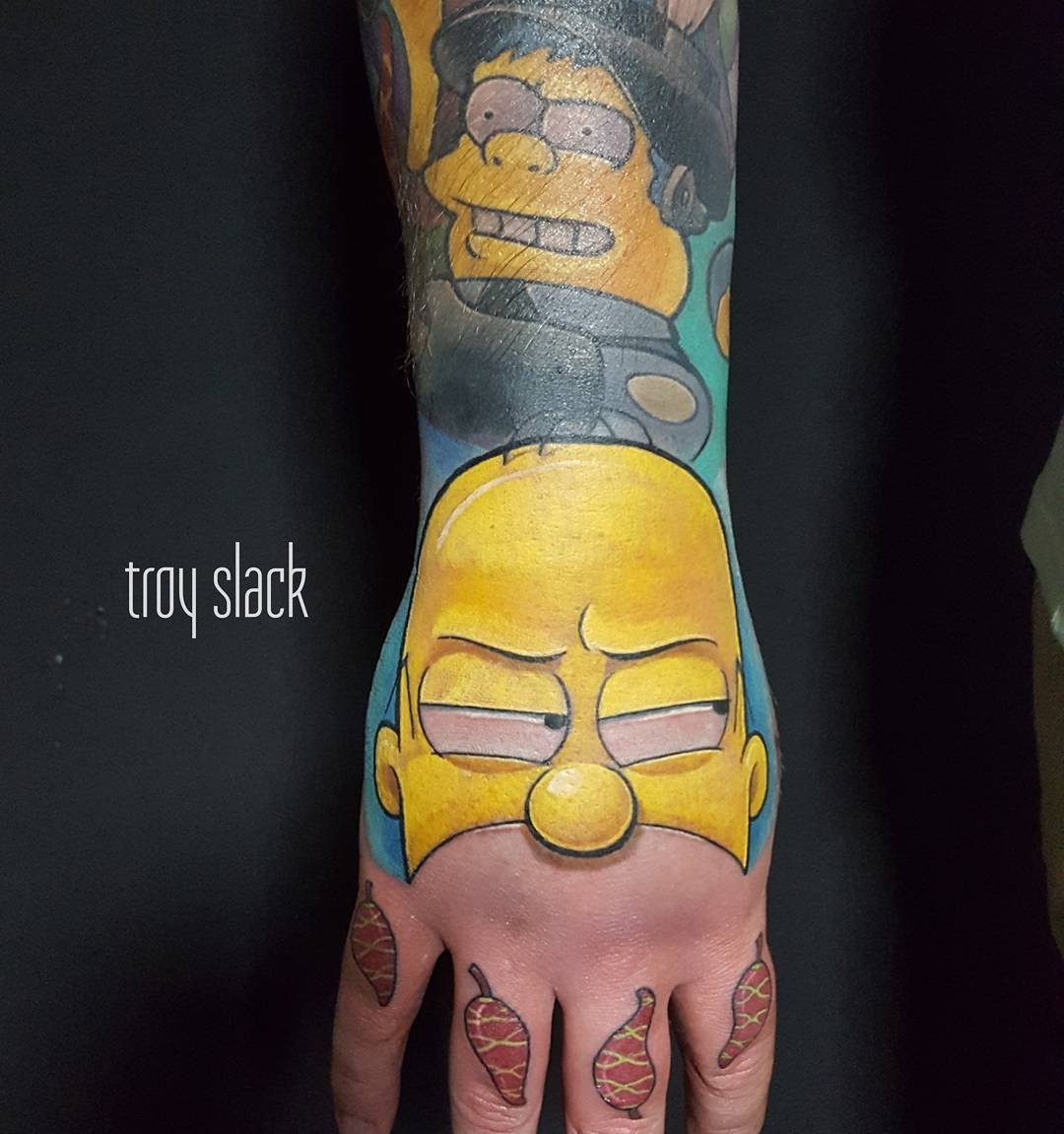 Homer Simpson tattoo on the wrist.